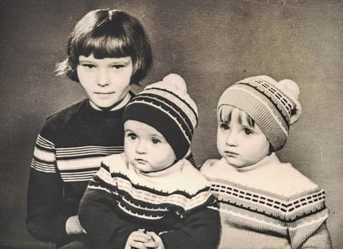 ZWICKAU, EAST GERMANY - CIRCA 1970: The retro photo shows small children-siblings. Studio portrait from the seventies last century.