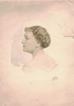 GERMANY - CIRCA 1910s: Vintage photo shows dreamy portrait of woman. Woman wears earrings, the neck and body is hand painted additionally. Black & white antique photography.