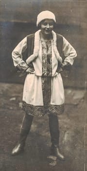 GERMANY - CIRCA 1930s: Vintage photo shows young girl wears traditional folk costum - ladies suit. Black and white photography. German tradition.