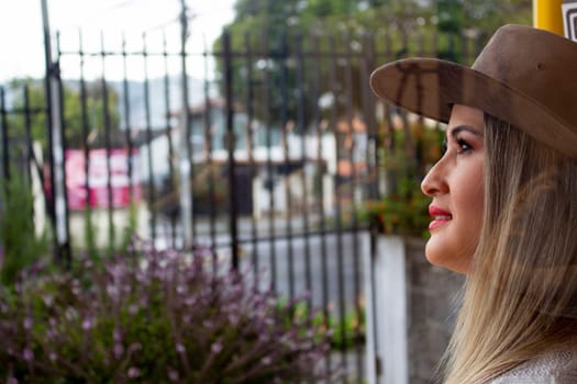 closeup with copy space of blonde girl in cowboy hat looking to the side. High quality photo