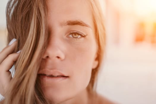 Happy woman portrait in cafe. Boho chic fashion style. Outdoor photo of young happy woman with long hair, sunny weather outdoors sitting in modern cafe