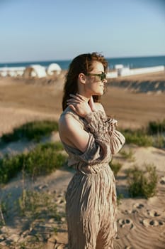 portrait of a woman in a light dress and sunglasses turning her head away from the camera. High quality photo