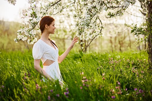 Pretty woman in blossom spring garden. High quality photo