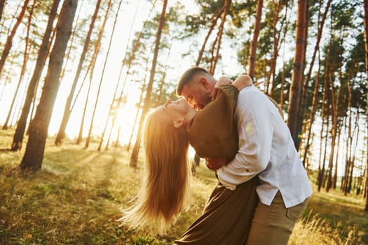 Feeling passion. Happy couple is outdoors in the forest at daytime.