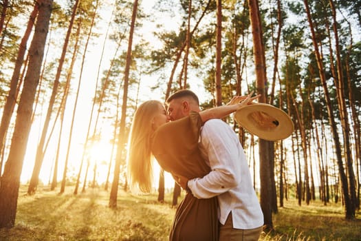 Feeling passion. Happy couple is outdoors in the forest at daytime.