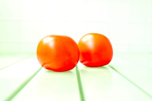 a glossy red, or occasionally yellow, pulpy edible fruit that is eaten as a vegetable or in salad.
