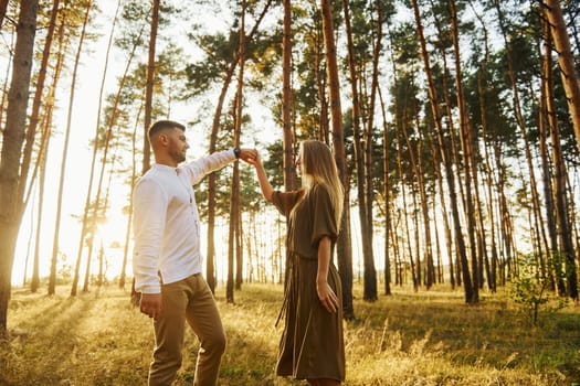 Closeness of the people. Happy couple is outdoors in the forest at daytime.