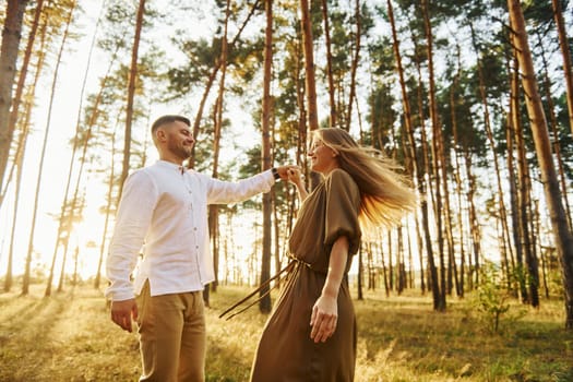 Closeness of the people. Happy couple is outdoors in the forest at daytime.