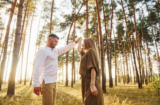 Closeness of the people. Happy couple is outdoors in the forest at daytime.