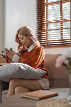 Portrait of pretty young woman looking at pictures from the camera.