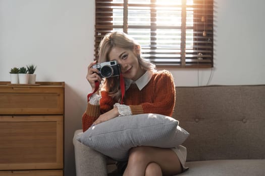 Portrait of pretty young woman taking picture on camera.