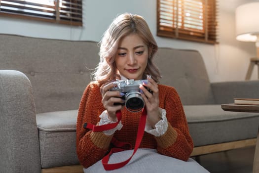 Portrait of pretty young woman looking at pictures from the camera.