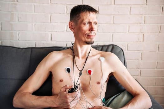 Holter Heart Monitor. man with cardio monitor, study of the work of the heart, cardiology. Medical diagnostics. Health care, hospital.ECG sensors and wires. electrocardiogram, measurement. diagnosis of heart diseases. Health control