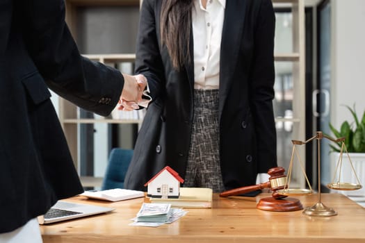 Lawyer business women shaking hands with clients, after finishing up a Consulting for insurance rent house. concept of home protection.