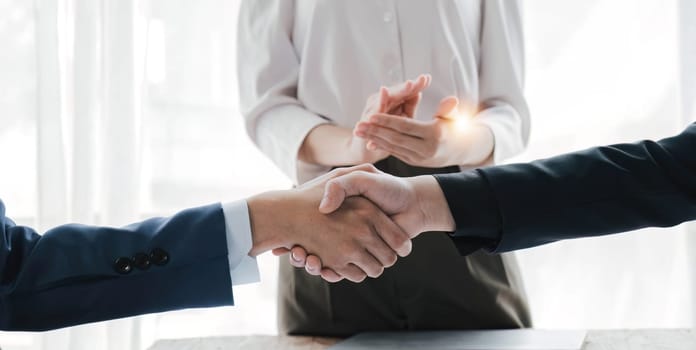 Business handshake for teamwork of business merger and acquisition,successful negotiate,hand shake,two businessman shake hand with partner to celebration partnership and business deal concept