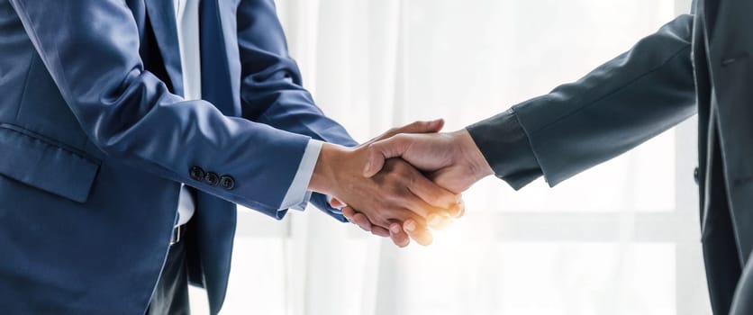 Business handshake for teamwork of business merger and acquisition,successful negotiate,hand shake,two businessman shake hand with partner to celebration partnership and business deal concept