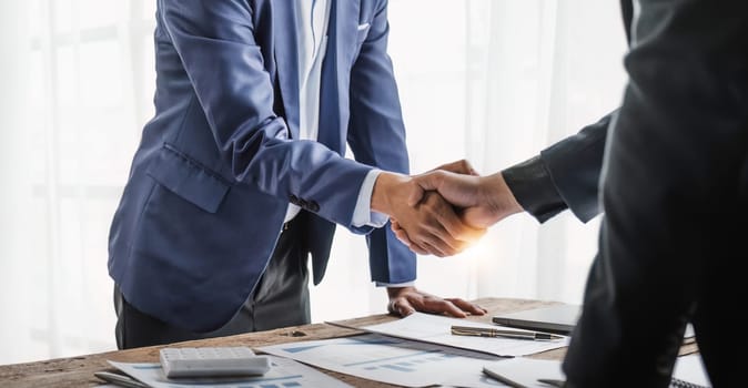 Business handshake for teamwork of business merger and acquisition,successful negotiate,hand shake,two businessman shake hand with partner to celebration partnership and business deal concept