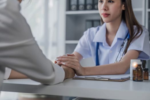 female doctor hold hand of caucasian woman patient give comfort, express health care sympathy, medical help trust support encourage reassure infertile patient at medical visit, closeup view...