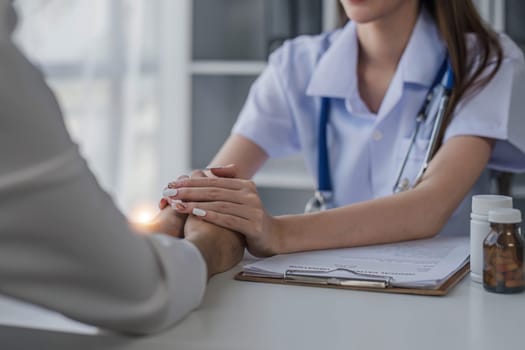 female doctor hold hand of caucasian woman patient give comfort, express health care sympathy, medical help trust support encourage reassure infertile patient at medical visit, closeup view...