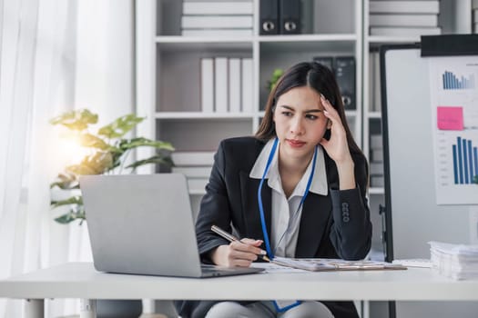 asian woman thinking hard concerned about online problem solution looking at laptop screen, worried serious asian businesswoman focused on solving difficult work computer task...