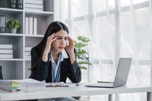 asian woman thinking hard concerned about online problem solution looking at laptop screen, worried serious asian businesswoman focused on solving difficult work computer task...