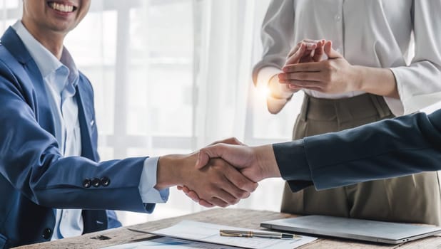 Business handshake for teamwork of business merger and acquisition,successful negotiate,hand shake,two businessman shake hand with partner to celebration partnership and business deal concept