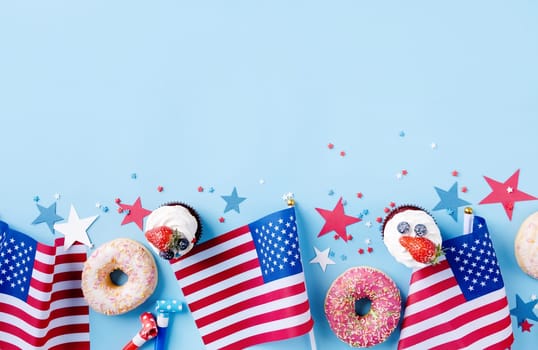 Fourth of july celebration. Sweet cupcakes and donuts with usa flag on blue background