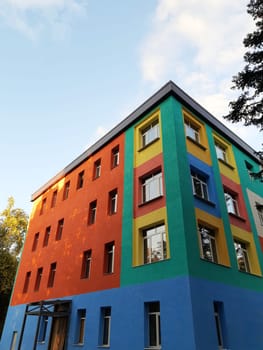 Multicolored colorful house against the blue sky in the city.