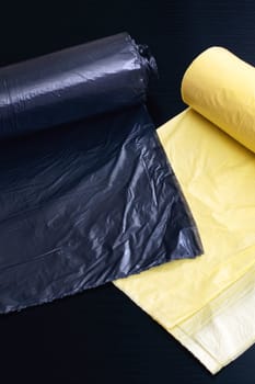 Yellow and gray garbage bags on a wooden table