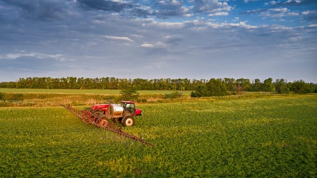 Sprayer CASE 3330 spraying pesticides on chickpea field. Field treatment with chemicals against pests, insects and plant diseases. Taking care of the Crop. 21.06.22, Rostov area. Russia