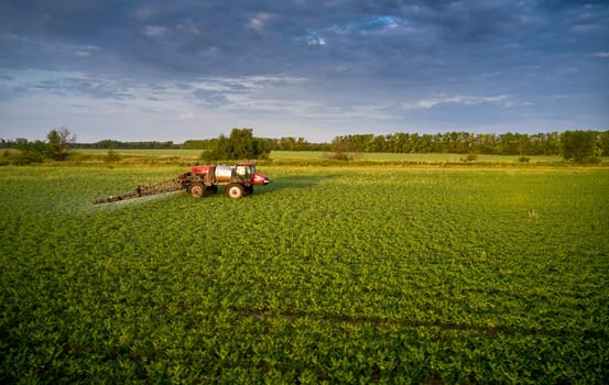 Sprayer CASE 3330 spraying pesticides on chickpea field. Field treatment with chemicals against pests, insects and plant diseases. Taking care of the Crop. 21.06.22, Rostov area. Russia