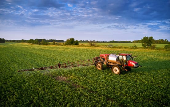 Sprayer CASE 3330 spraying pesticides on chickpea field. Field treatment with chemicals against pests, insects and plant diseases. Taking care of the Crop. 21.06.22, Rostov area. Russia