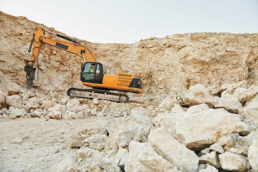 Loading vehicle is outdoors on the borrow pit at daytime.