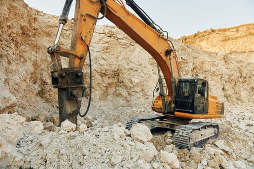 Loading vehicle is outdoors on the borrow pit at daytime.