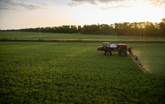 Sprayer CASE 3330 spraying pesticides on chickpea field. Field treatment with chemicals against pests, insects and plant diseases. Taking care of the Crop. 21.06.22, Rostov area. Russia