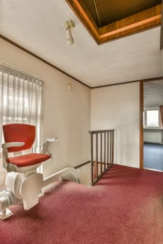 a dentist's chair in the corner of a room with an open door leading to another room that is empty