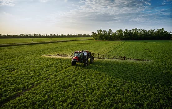 Sprayer CASE 3330 spraying pesticides on chickpea field. Field treatment with chemicals against pests, insects and plant diseases. Taking care of the Crop. 21.06.22, Rostov area. Russia