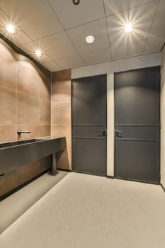 a bathroom with two black doors and a sink in the middle one door is on the other side of the room
