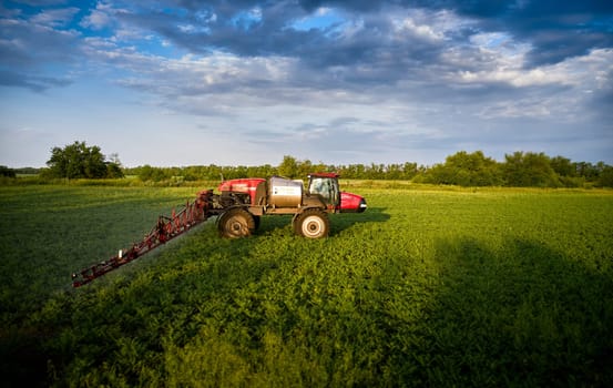 Sprayer CASE 3330 spraying pesticides on chickpea field. Field treatment with chemicals against pests, insects and plant diseases. Taking care of the Crop. 21.06.22, Rostov area. Russia