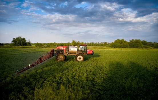 Sprayer CASE 3330 spraying pesticides on chickpea field. Field treatment with chemicals against pests, insects and plant diseases. Taking care of the Crop. 21.06.22, Rostov area. Russia