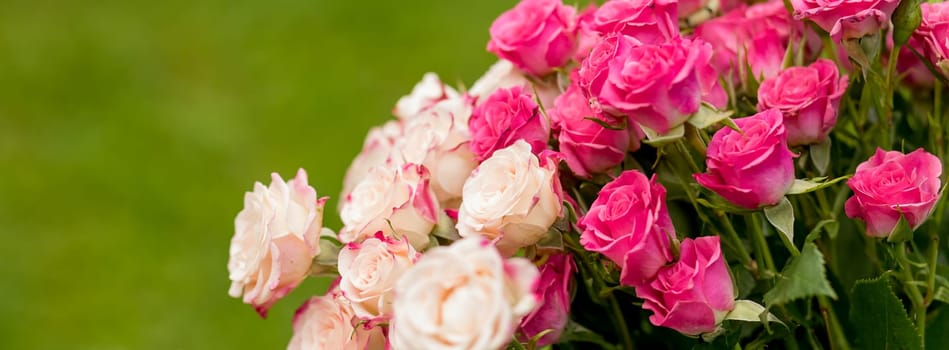 Small roses bouquet on light grey textured background with copy space