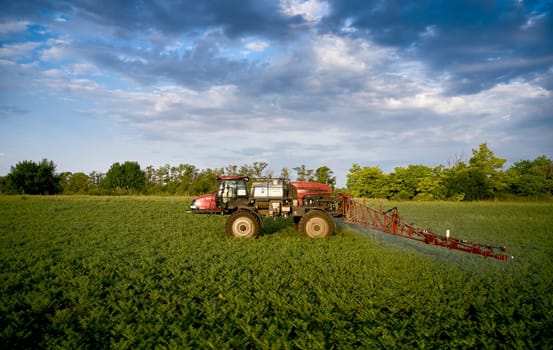 Sprayer CASE 3330 spraying pesticides on chickpea field. Field treatment with chemicals against pests, insects and plant diseases. Taking care of the Crop. 21.06.22, Rostov area. Russia