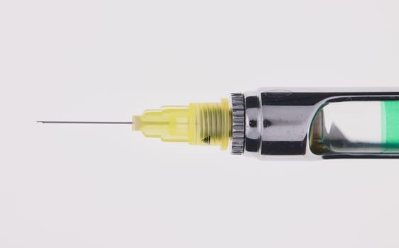 Steel dental syringe for local anesthesia, isolated on white. Carpool syringe for anesthesia in dentistry. Thin needle on a syringe for anesthesia in dentistry.