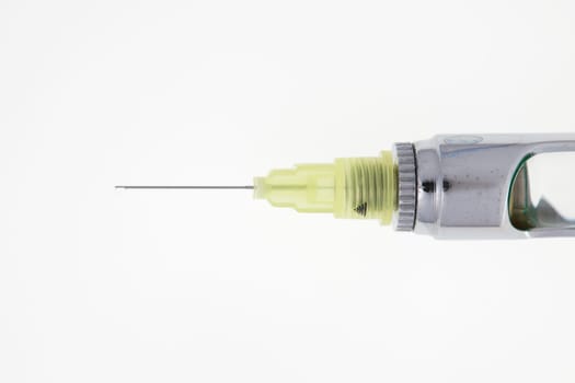 Steel dental syringe for local anesthesia, isolated on white. Carpool syringe for anesthesia in dentistry. Thin needle on a syringe for anesthesia in dentistry.