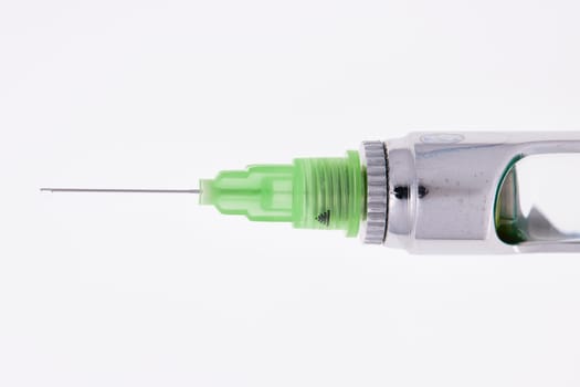 Steel dental syringe for local anesthesia, isolated on white. Carpool syringe for anesthesia in dentistry. Thin needle on a syringe for anesthesia in dentistry.
