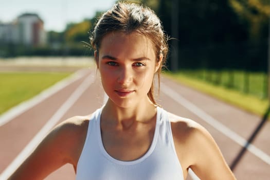 Portrait of young woman in sportive clothes that is exercising outdoors.