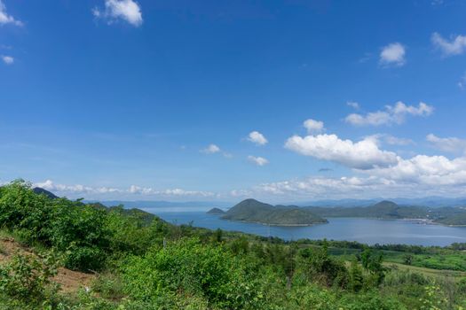 Clear blue sky white clouds, trees, natural grass trees around the Srinakarin Reservoir, Kanchanaburi, Thailand