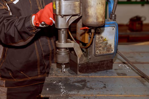 Drilling holes in metal poles for attaching various parts to the poles or connecting the poles to each other.