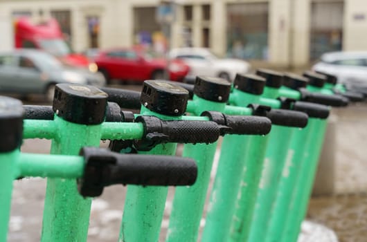 Electric scooters for public use standing in the center of a European city. Public transport