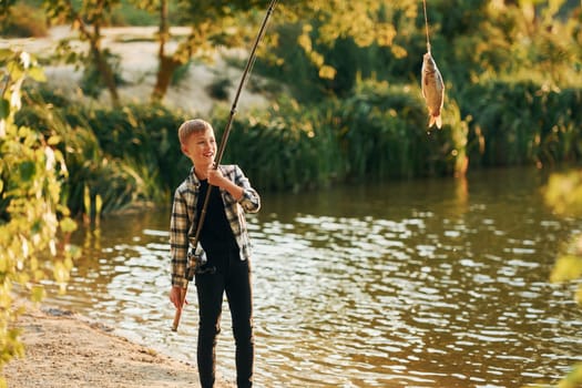 Boy in casual clothes in on fishion outdoors at summertime.